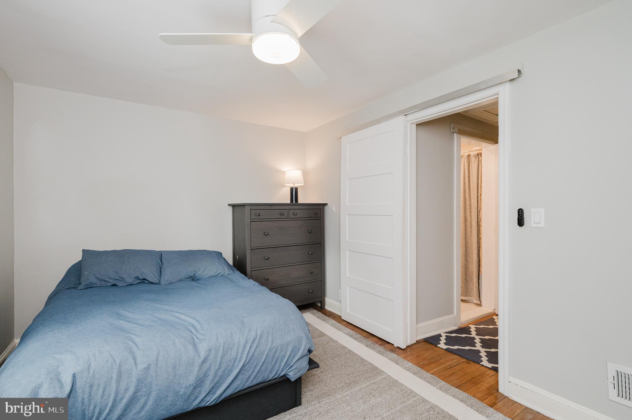 616 Sudbrook Road Baltimore, MD 21208 - Photo 39 of 58 a bedroom with a bed and wooden floor