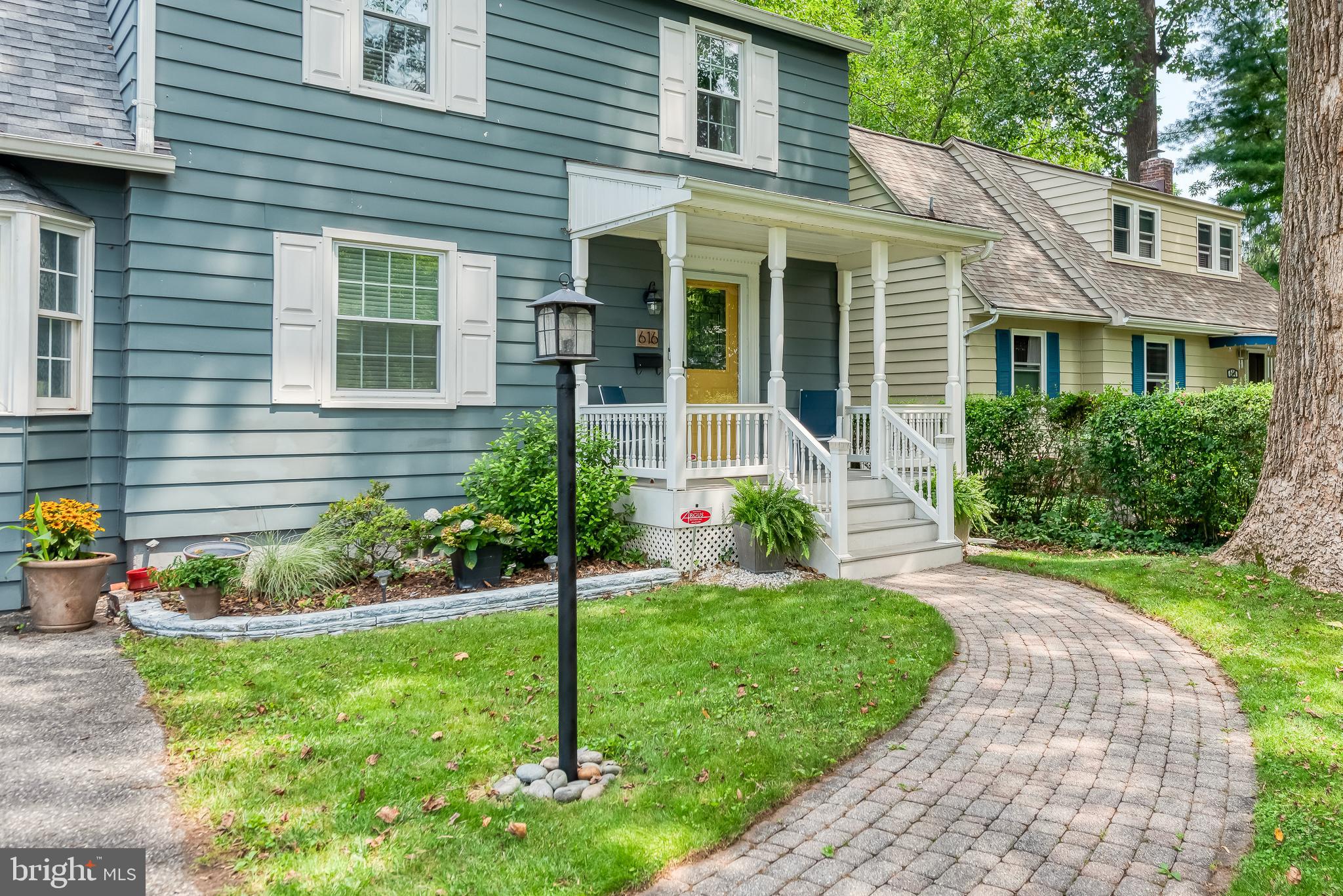 616 Sudbrook Road Baltimore, MD 21208 - Photo 6 of 58 a front view of a house with a yard and potted plants