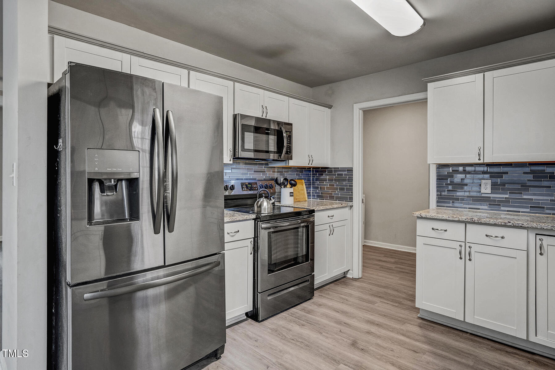 1506 Poplar Ridge Road Fuquay-Varina, NC 27526 - Photo 12 of 29 a kitchen with stainless steel appliances a refrigerator sink and microwave