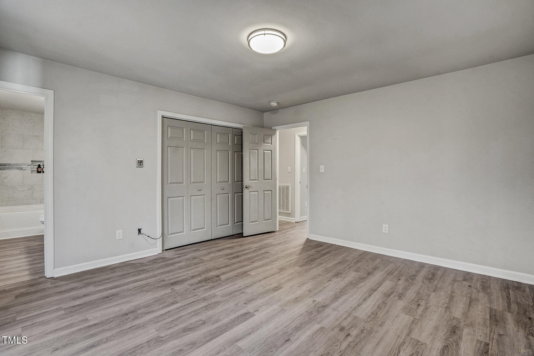 1506 Poplar Ridge Road Fuquay-Varina, NC 27526 - Photo 19 of 29 a view of an empty room with wooden floor