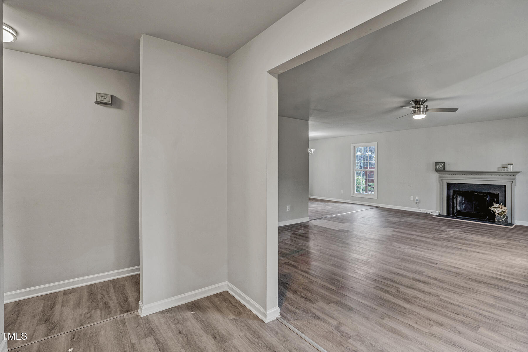 1506 Poplar Ridge Road Fuquay-Varina, NC 27526 - Photo 4 of 29 a view of a livingroom with wooden floor and a fireplace