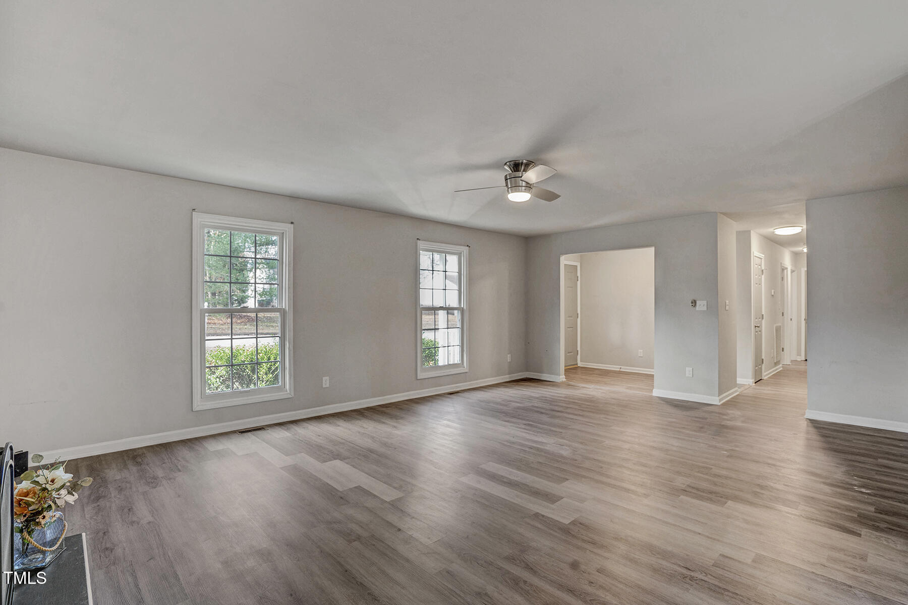 1506 Poplar Ridge Road Fuquay-Varina, NC 27526 - Photo 7 of 29 an empty room with wooden floor and window
