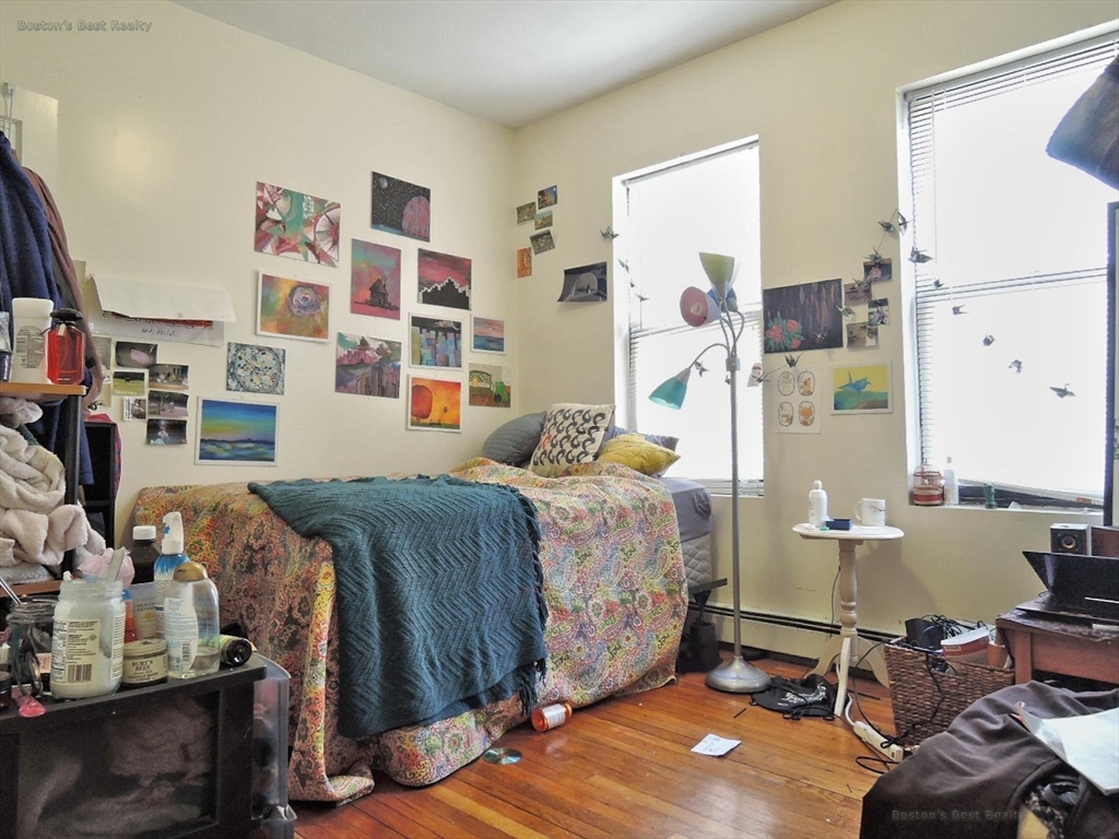 181 Allston, Unit 2 Boston, MA 02134 - Photo 9 of 18 a bedroom with furniture and a lamp