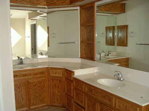 2429 Handlin Drive Corpus Christi, TX 78418 - Photo 4 of 9 a bathroom with a granite countertop sink and a mirror