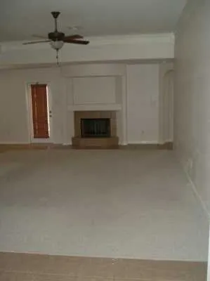 a view of empty room with a fireplace