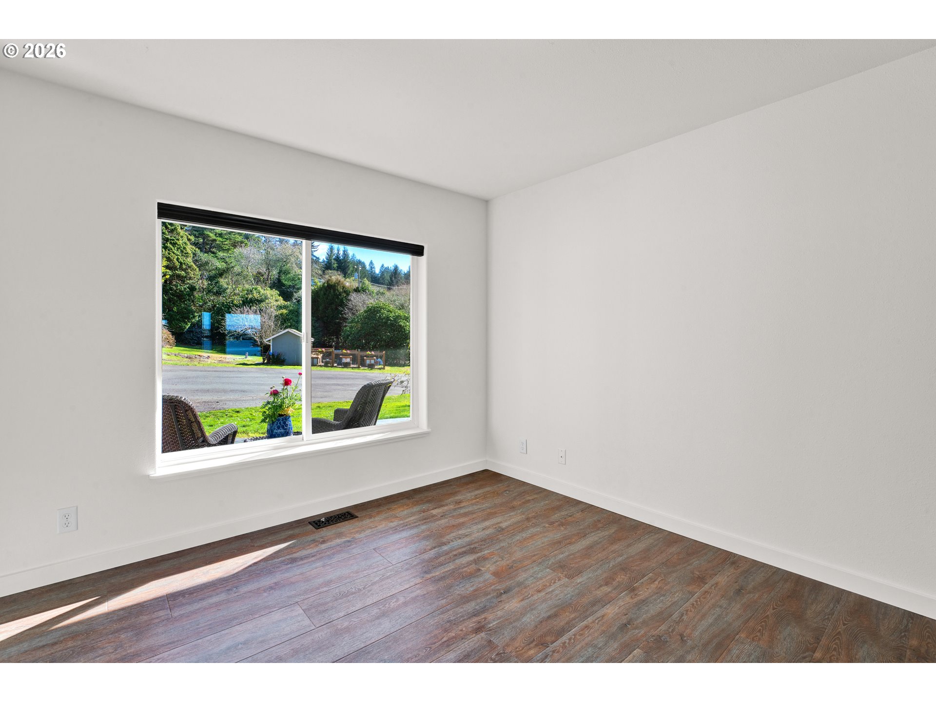 85675 Glenada Road Florence, OR 97439 - Photo 24 of 42 an empty room with wooden floor and windows