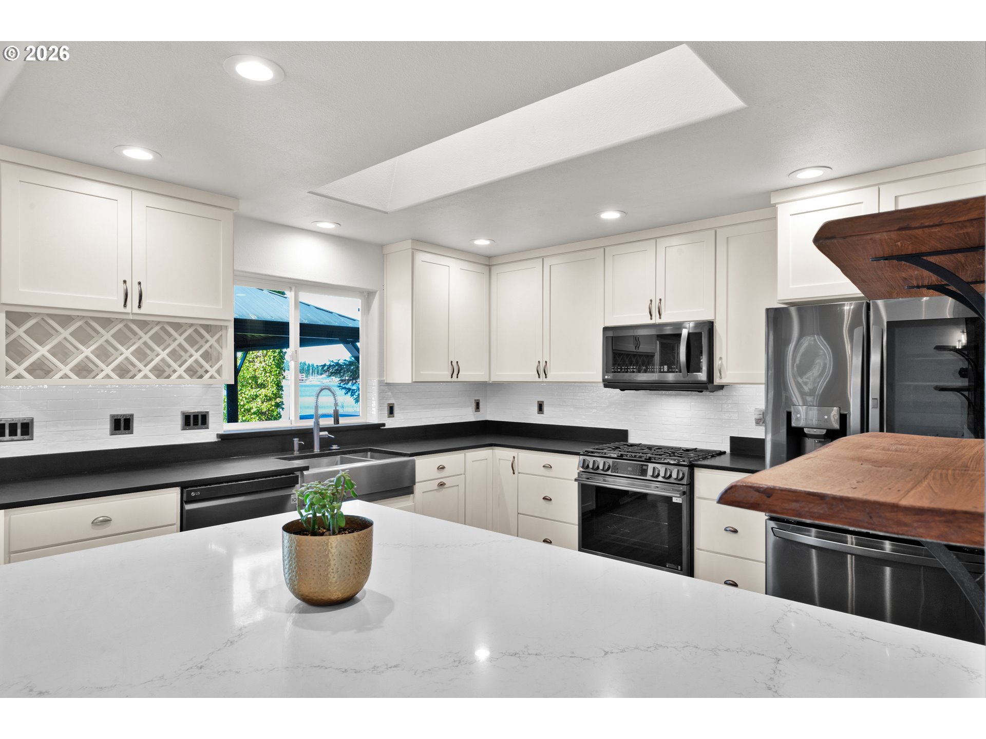 85675 Glenada Road Florence, OR 97439 - Photo 10 of 42 a kitchen with stainless steel appliances and white cabinets