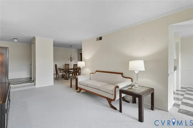 a living room with furniture a lamp and a table