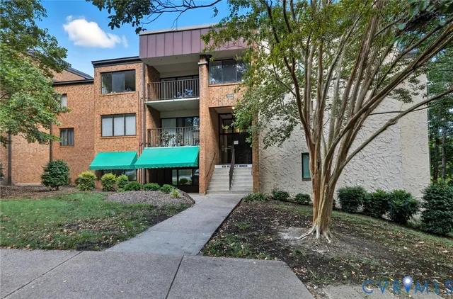 a view of a brick building next to a yard