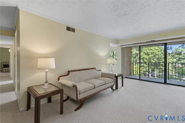 a living room with furniture and a lamp