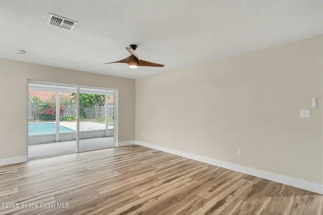 a view of wooden floor and windows in a room