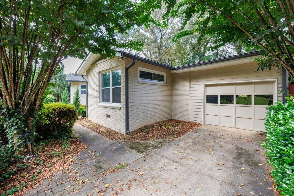 3838 Longview Drive Chamblee, GA 30341 - Photo 11 of 45 a front view of a house with a garden