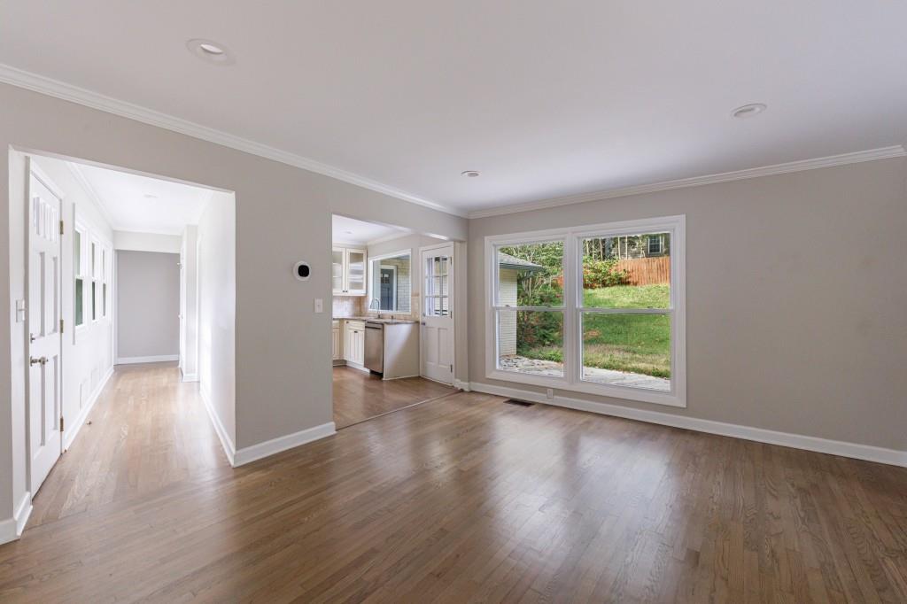 3838 Longview Drive Chamblee, GA 30341 - Photo 16 of 45 a view of a big room with wooden floor and windows