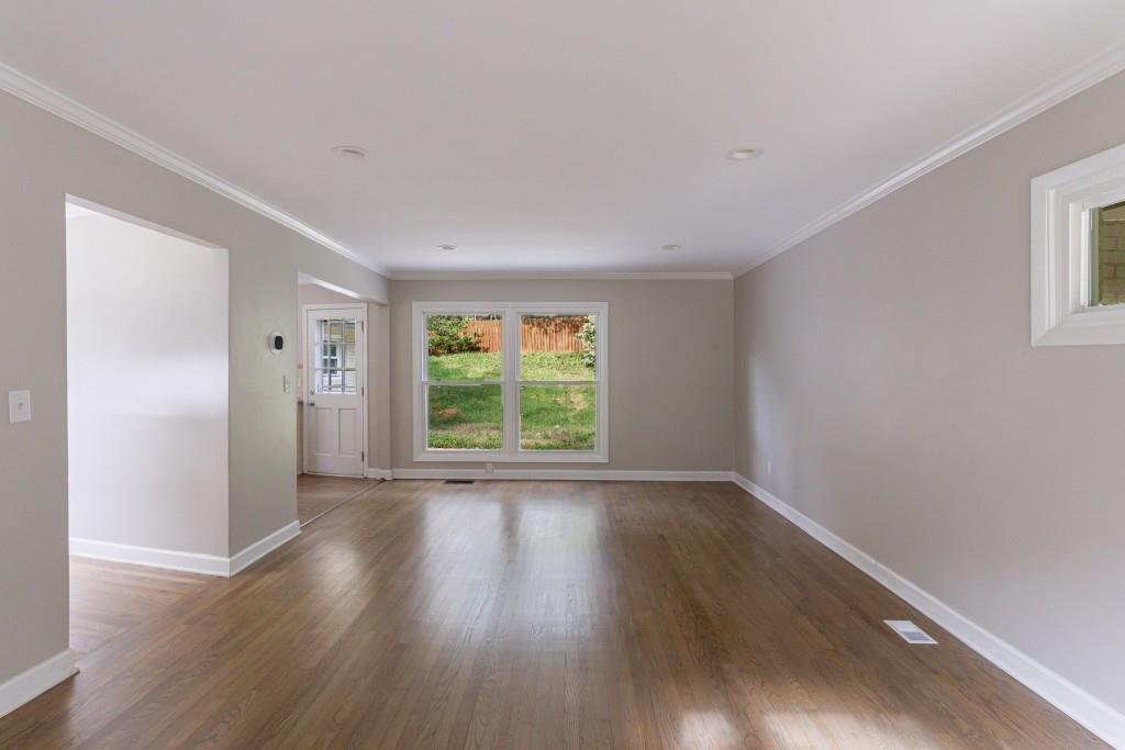 3838 Longview Drive Chamblee, GA 30341 - Photo 17 of 45 a view of an empty room with wooden floor and a window