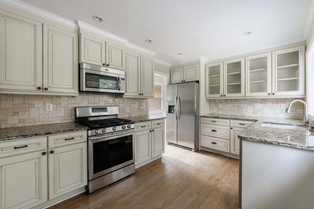 3838 Longview Drive Chamblee, GA 30341 - Photo 18 of 45 a kitchen with stainless steel appliances granite countertop a stove sink microwave and cabinets
