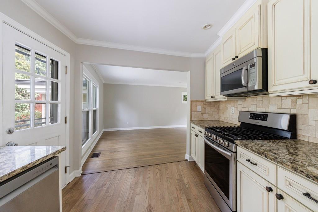 3838 Longview Drive Chamblee, GA 30341 - Photo 23 of 45 a kitchen with granite countertop cabinets stainless steel appliances and a window