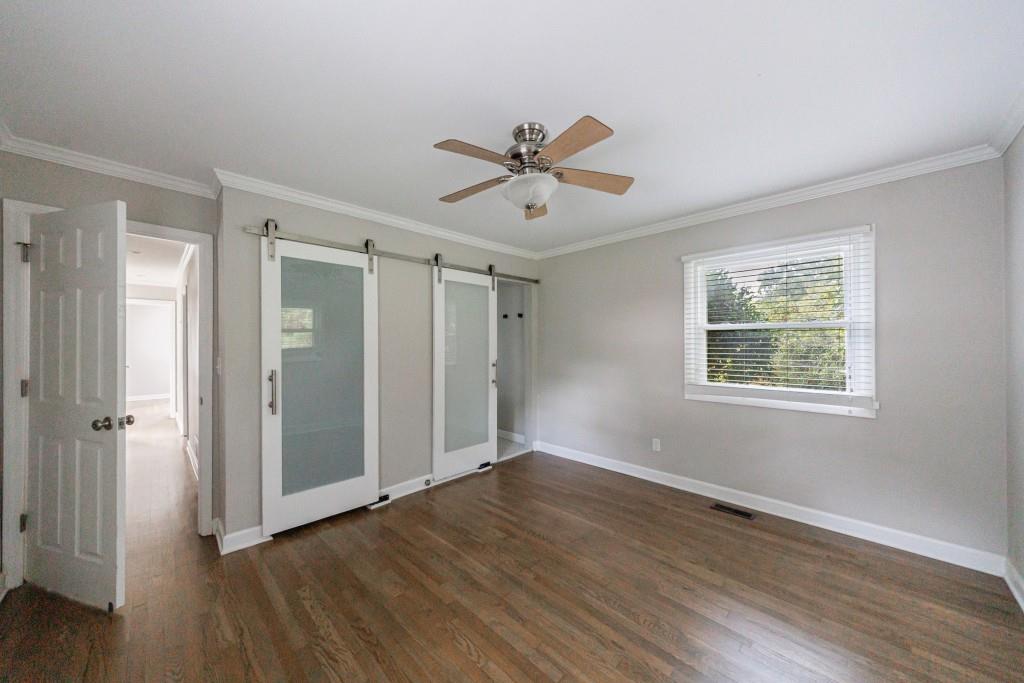 3838 Longview Drive Chamblee, GA 30341 - Photo 29 of 45 an empty room with wooden floor and windows