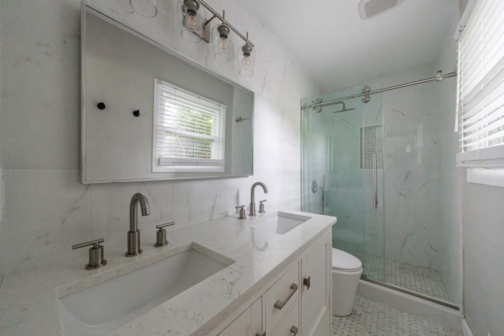 3838 Longview Drive Chamblee, GA 30341 - Photo 7 of 45 a bathroom with a sink shower and a toilet