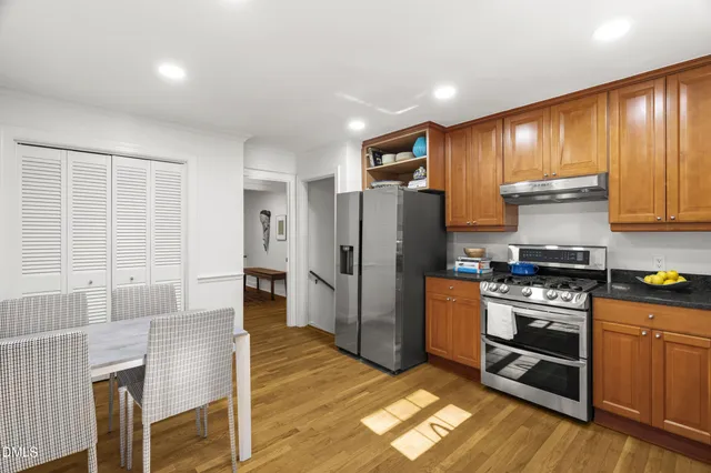 a kitchen with stainless steel appliances granite countertop a stove a sink dishwasher and a refrigerator
