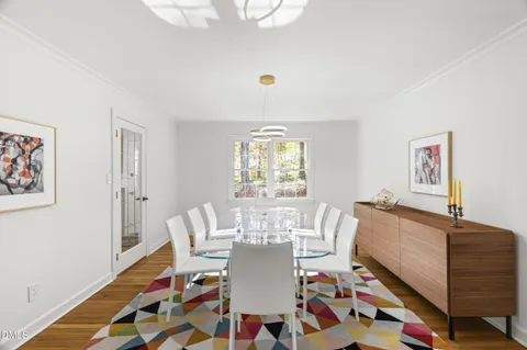 a view of a dining room with furniture and wooden floor