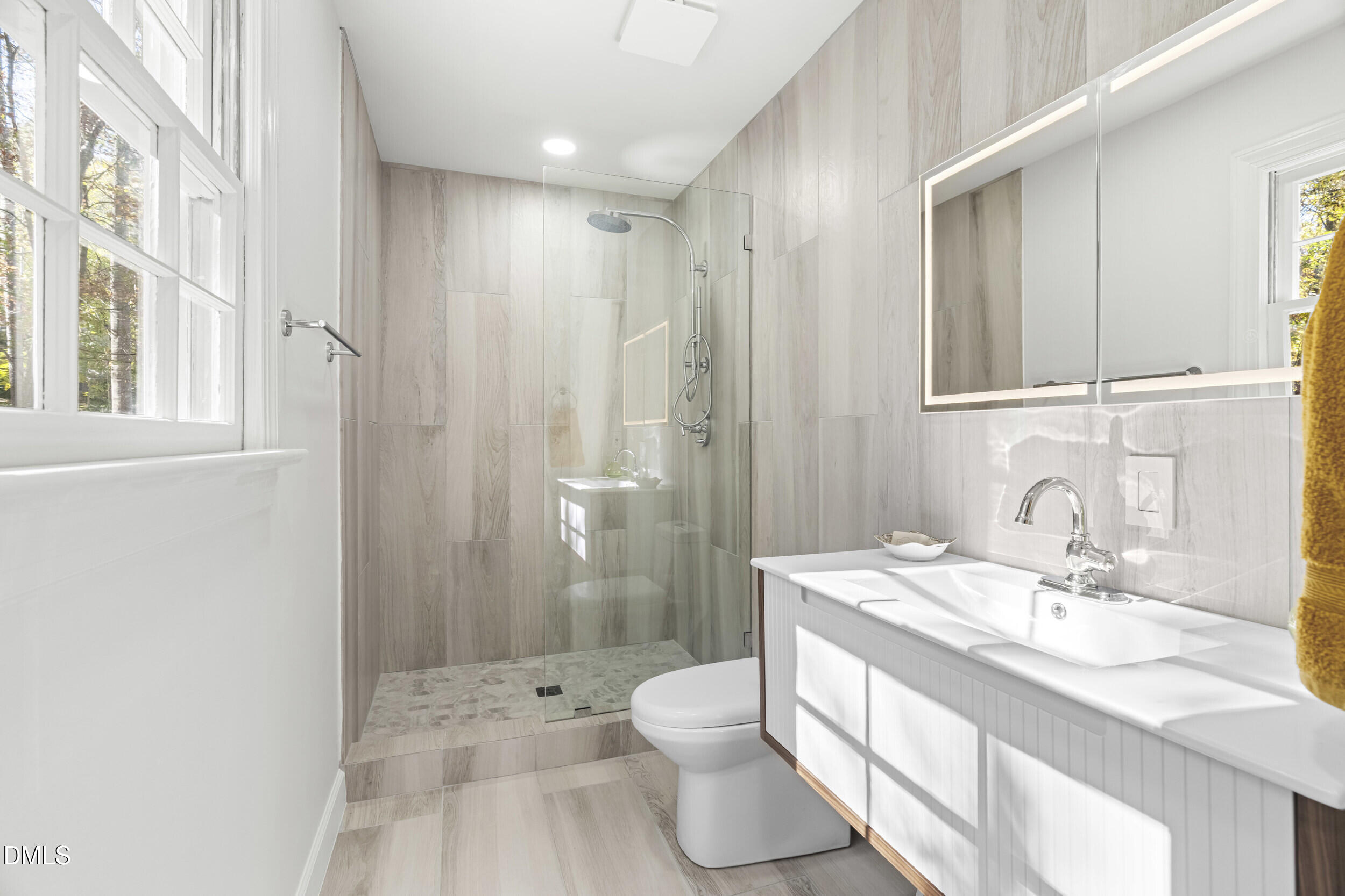 2105 Yorkgate Drive Raleigh, NC 27612 - Photo 21 of 42 a bathroom with a granite countertop sink a toilet a large mirror and shower