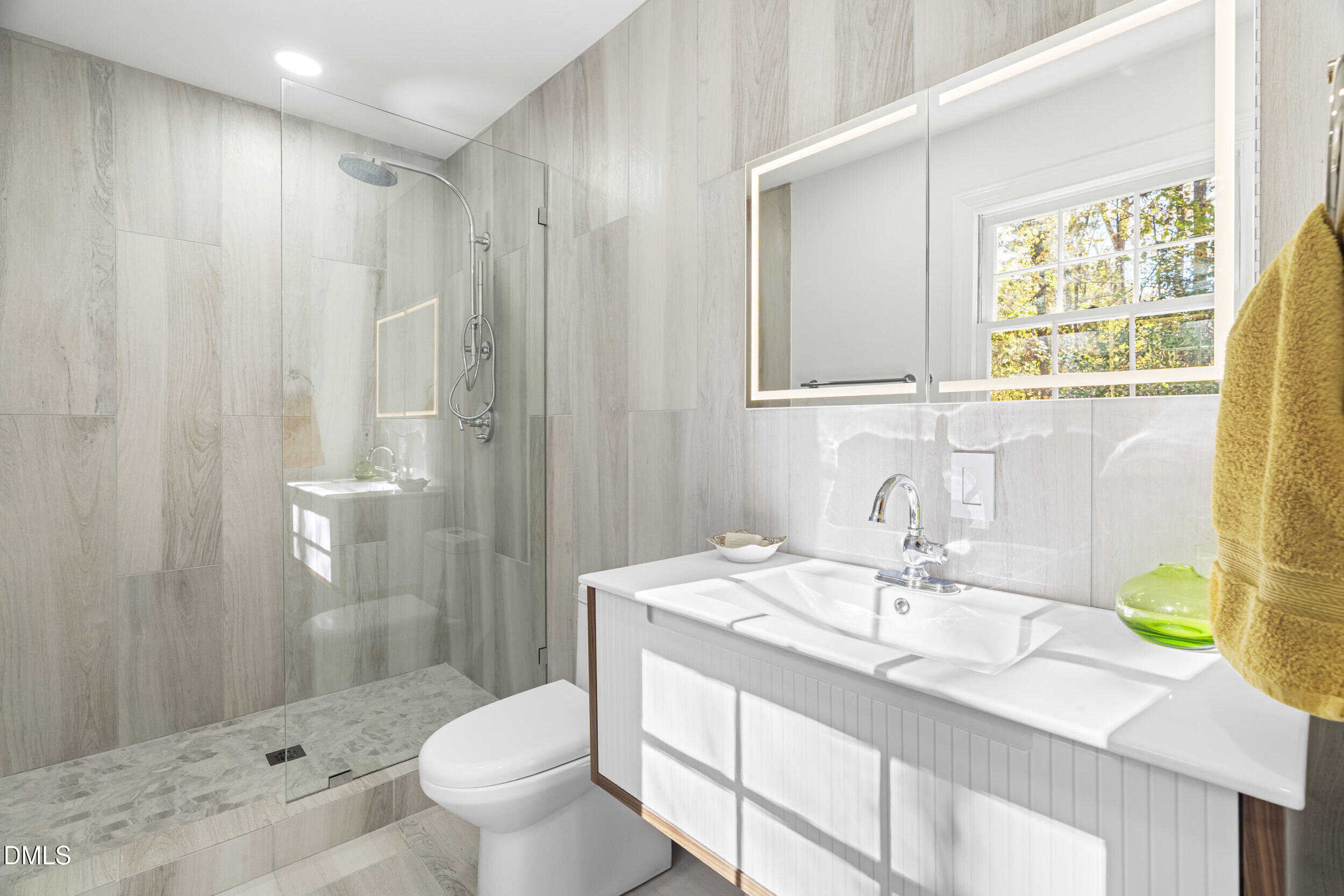 2105 Yorkgate Drive Raleigh, NC 27612 - Photo 22 of 42 a bathroom with a granite countertop sink a toilet and a shower