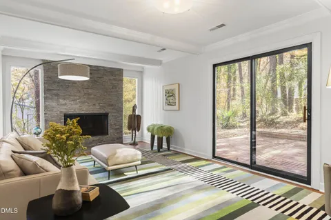 a living room with furniture a fireplace and a table