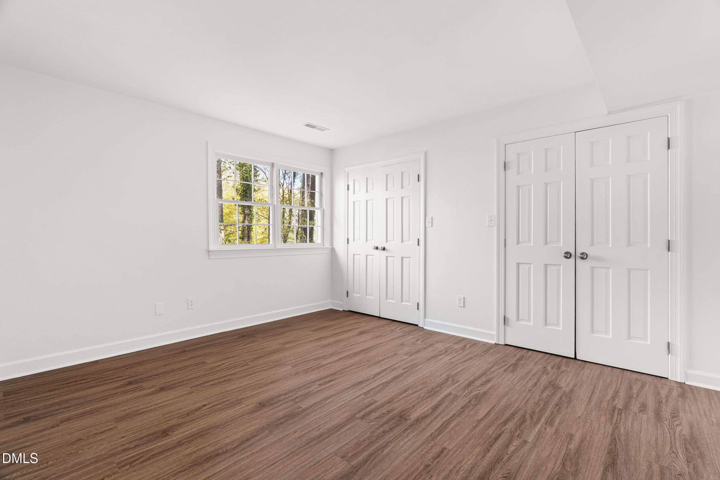 2105 Yorkgate Drive Raleigh, NC 27612 - Photo 31 of 42 a view of an empty room with wooden floor and a window