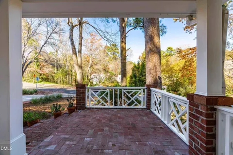 a front view of a house with a yard and tree s