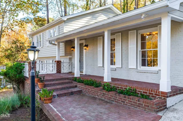 a front view of a house with a yard and outdoor seating