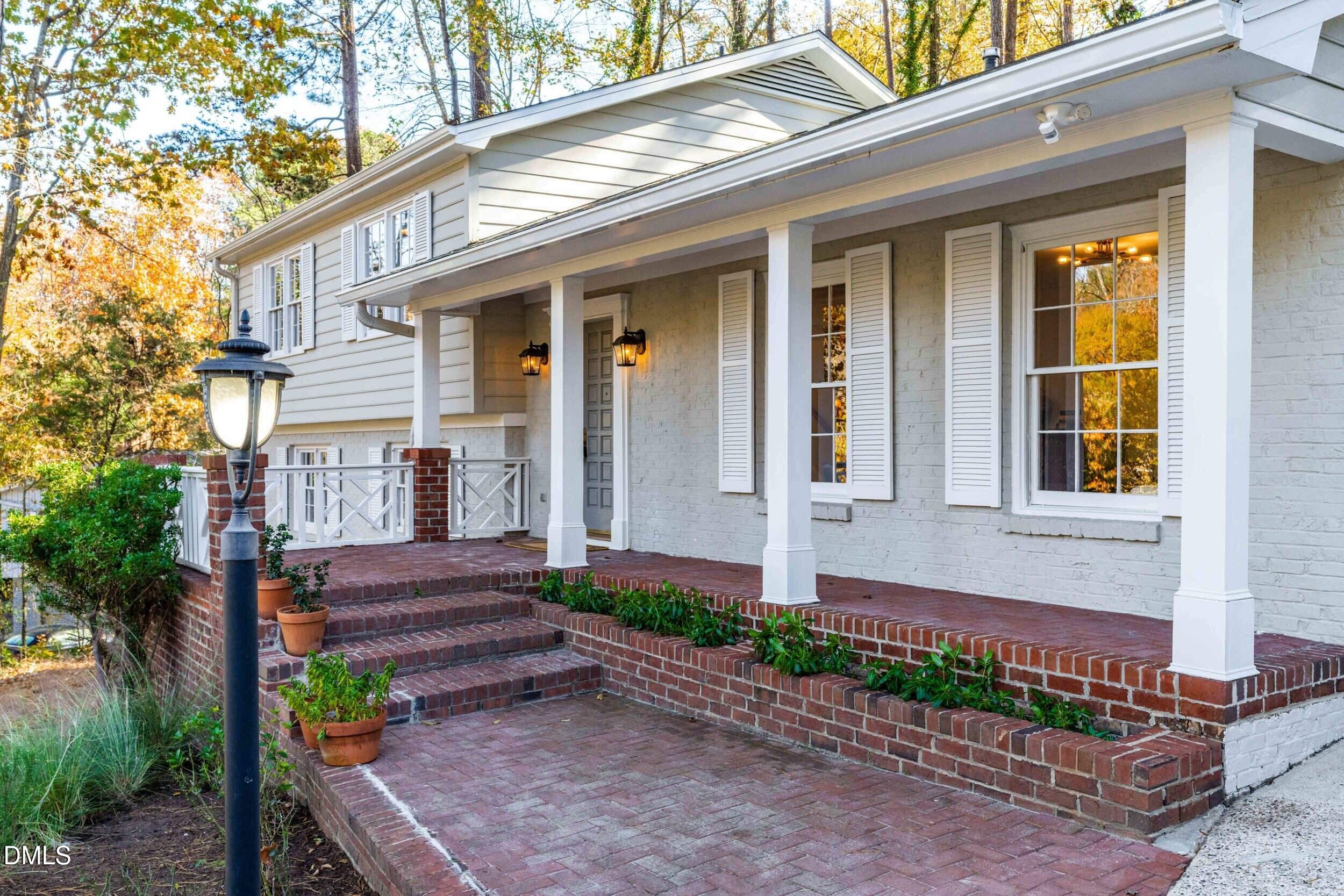 2105 Yorkgate Drive Raleigh, NC 27612 - Photo 3 of 42 a front view of a house with a yard and outdoor seating