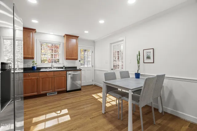 a kitchen with granite countertop stainless steel appliances a sink stove and cabinets