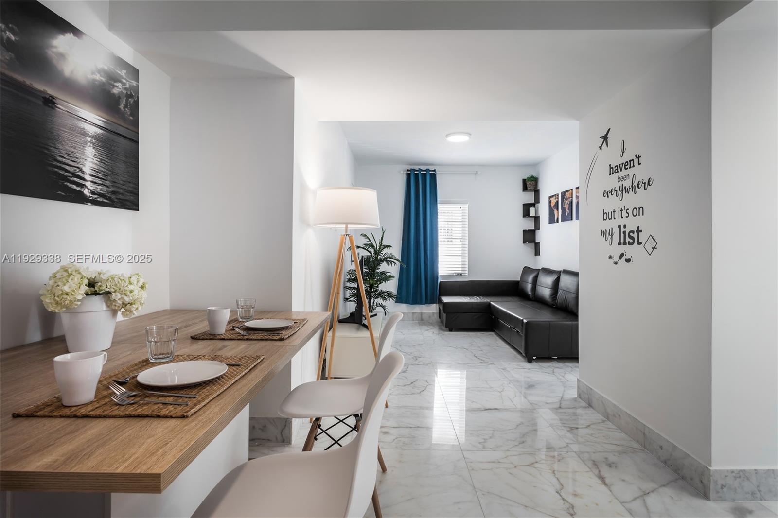 807 Alton Road Miami Beach, FL 33139 - Photo 4 of 7 a living room with furniture and a table