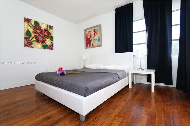 a spacious bedroom with a bed and a window