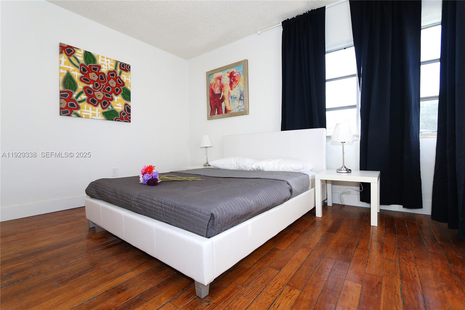 807 Alton Road Miami Beach, FL 33139 - Photo 6 of 7 a spacious bedroom with a bed and a window