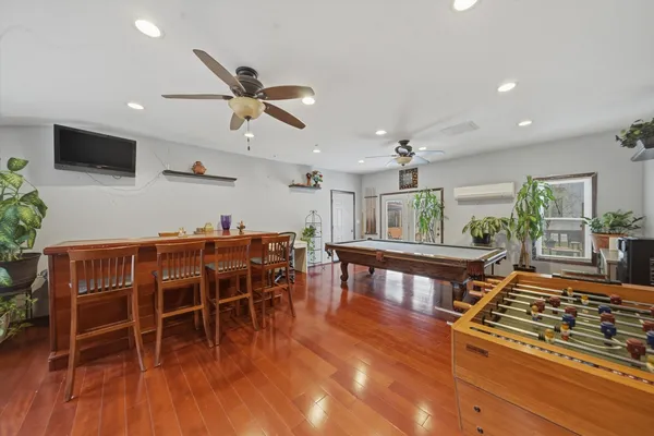 a living room with furniture a wooden floor and a window