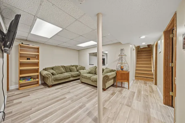 a living room with furniture and a wooden floor