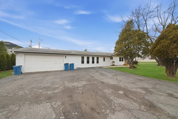 a view of a house with a yard and garage