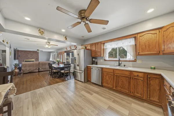 a kitchen with sink cabinets and wooden floor