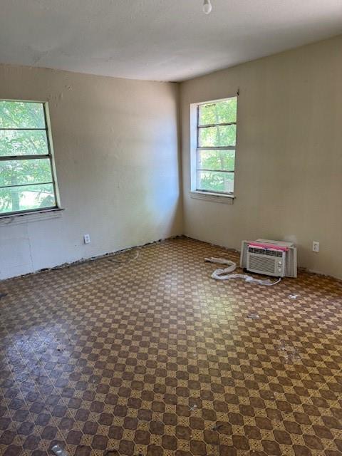 9800 North County Road Frisco, TX 75033 - Photo 11 of 14 Unfurnished room featuring a textured ceiling and a wall mounted air conditioner