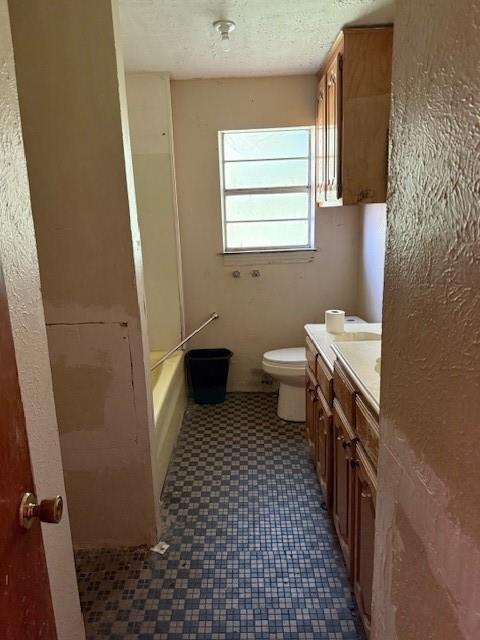 9800 North County Road Frisco, TX 75033 - Photo 12 of 14 Full bath with vanity, shower / tub combination, a textured wall, and a textured ceiling