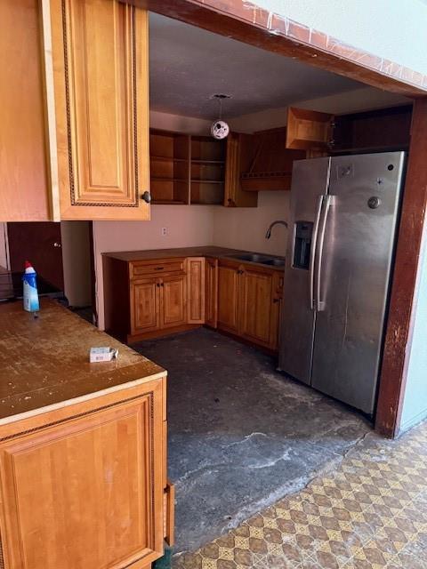 9800 North County Road Frisco, TX 75033 - Photo 6 of 14 Kitchen featuring refrigerator, brown cabinets, and dark flooring