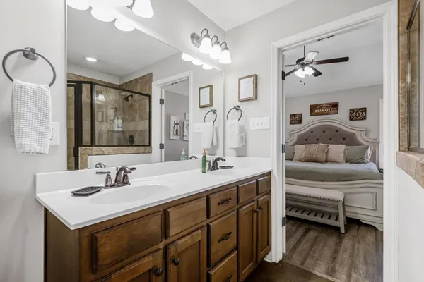 a en suite bathroom with a double vanity sink mirror and