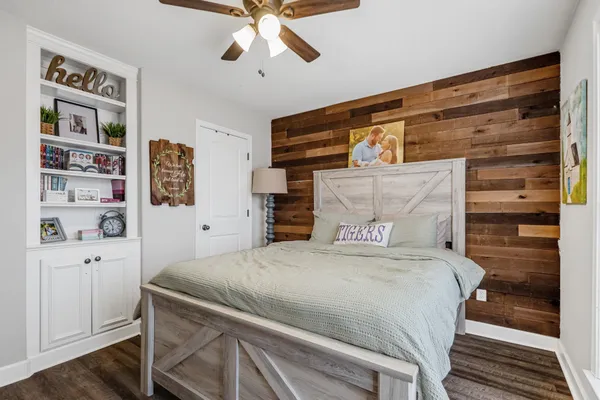 a bedroom with a bed and a chandelier
