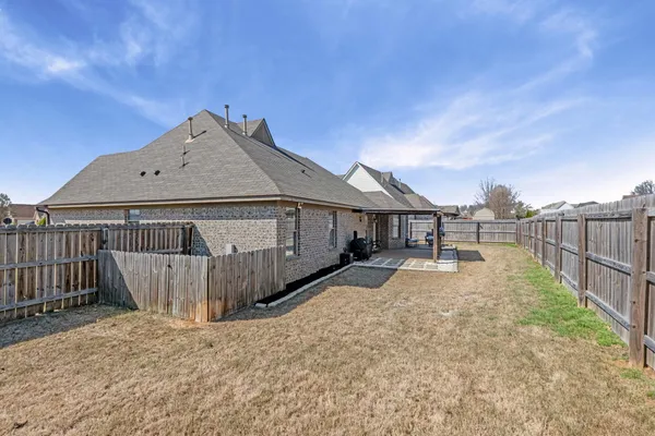 a view of a house with wooden fence