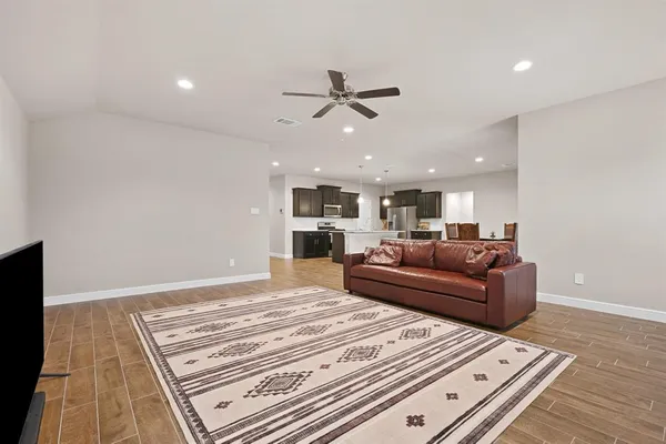 a living room with a couch and a ceiling fan