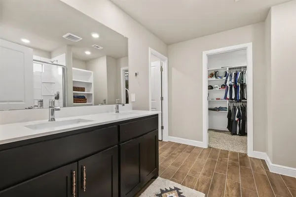 a bathroom with a sink double vanity and a mirror