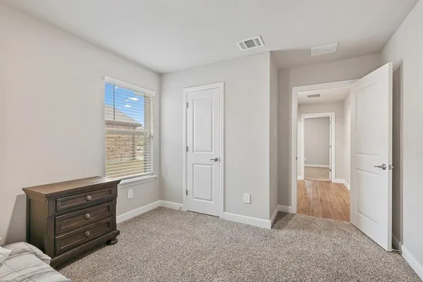 a view of room with cabinet and windows