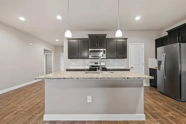 a large kitchen with stainless steel appliances kitchen island a large island in the center