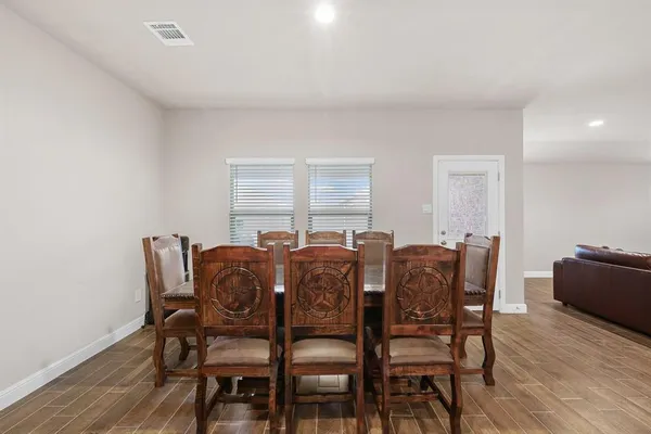 a view of a dining room with furniture and wooden floor